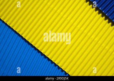 Diagonally ribbed cardboard with the colors blue, yellow, indigo. Meant as background Stock Photo