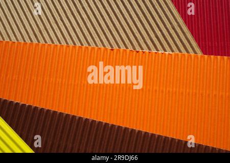 Diagonally ribbed cardboard with the colors beige, red, orange, brown and yellow. Meant as background Stock Photo