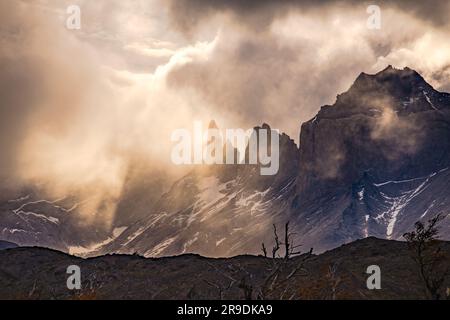 Mystic light mood backlit at Torres del Paine National Park with clouds and mountains, Chile Stock Photo