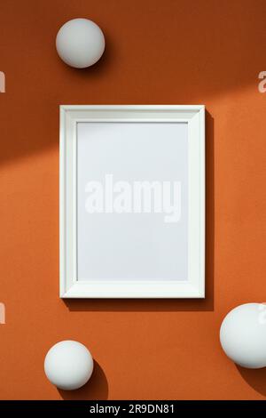 Blank white picture frame mockup on brown background Stock Photo