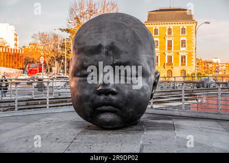 Madrid, Spain-FEB 17, 2022: Bronze gigantic baby head sculptures by Antonio Lopez Garcia at the Puerta de Atocha central railway station in Madrid, Sp Stock Photo