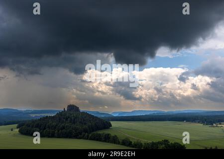 View over Bohemian Switzerland near Schöna, Germany. Dramatic clouds over the Kaiserkrone, a rock formation in Saxon Switzerland. Stage on the 15 km long circular trail from Krippen Stock Photo