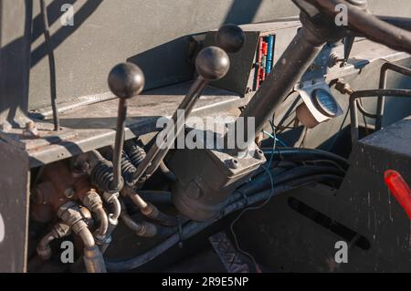 Detail of the interior of an old tractor in an industrial environment.close-up on the levers inside Stock Photo