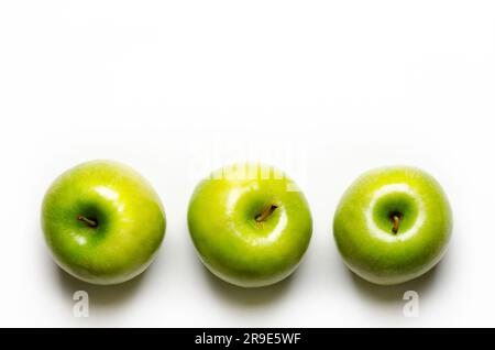 Three green apples on white background with copy space. Stock Photo