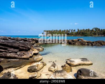 Secret beach at koh kood, Thailand. Bright seascape background on sunny day. Summer background with rocks, clear sea water and open blue sky on sunshi Stock Photo