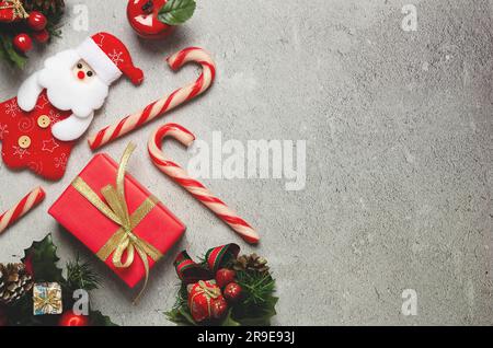 Christmas decoration in red, green and golden on grey background with copy space. Stock Photo