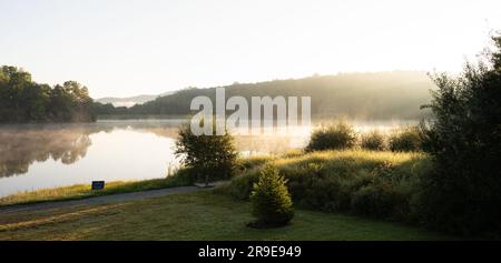 Steam rises over the small pond at scenic Sweetgrass development in Western North Carolina near Blowing Rock, NC on a summer morning. Stock Photo