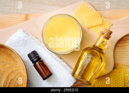 Woman hands apply homemade beeswax wood treatment polish to restore natural  wood bowl color. Beeswax, olive oil and essential oil, soft cloth Stock  Photo - Alamy