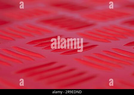 Close up image of a red non slip metallic floor creating an abstract image. Stock Photo