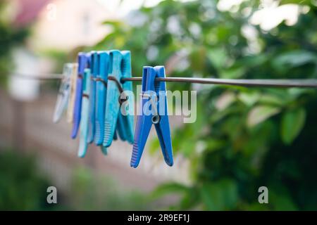 Multi-colored clothespins on a clothesline close up. Stock Photo