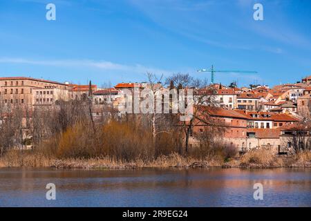 Salamanca, Spain-FEB 20, 2022: Cityscape of Salamanca by the bank of Tormes River. Stock Photo