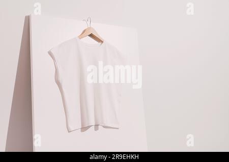 Blank white t-shirt mockup, template on wooden hanger Stock Photo