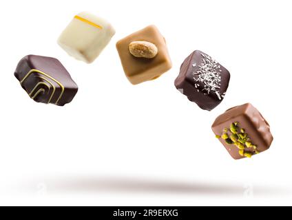 Assorted chocolate pralines floating on white background Stock Photo