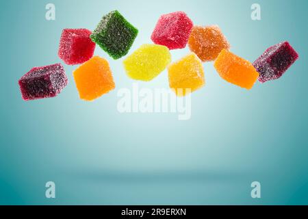 assorted jelly candies floating on blue background. Stock Photo