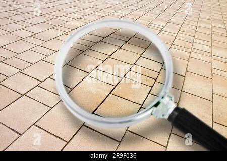 New paving made with stone blocks of rectangular shape in a pedestrian zone - Concept image seen through a magnifying glass Stock Photo