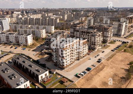 Drone photography of new housing spread in suburbs and old high rise. High angle view Stock Photo