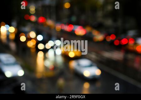 Blurry vehicles and bokeh lights on a road at night time in Istanbul. High-angle view of blurry traffic jam. Stock Photo