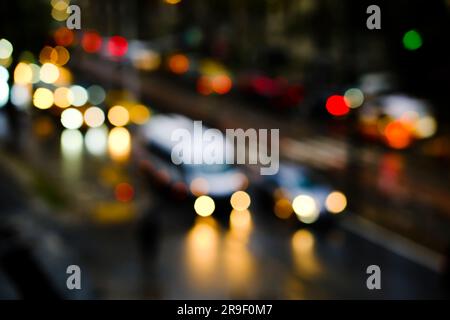 Blurry vehicles and bokeh lights on a road at night time in Istanbul. High-angle view of blurry traffic jam. Stock Photo