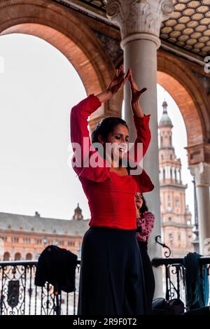 Seville, Spain - Feb 24, 2022: Street artist performing flameco art with dancing and live music at the Plaza de Espana in Seville, Andalusia, Spain.