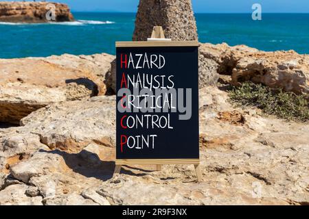 HACCP symbol. Concept words HACCP hazard analysis critical control point on black blackboard. Beautiful stone background. Business HACCP hazard analys Stock Photo