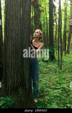 girl teenager in a deciduous grove with trees Stock Photo