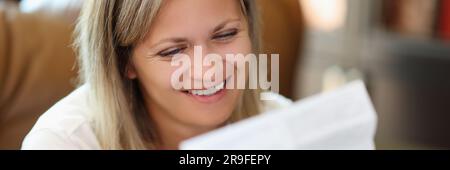 Smiling woman reading instructions for medical use of pills Stock Photo