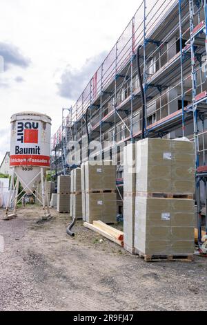 Energy renovation of a multi-family house, thermal insulation, new windows and new roofing, Stock Photo