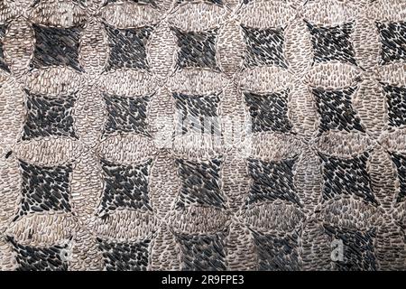 Ancient pebble pavement close up with decorative pattern Stock Photo