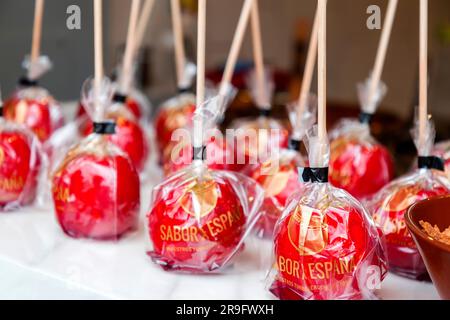 Granada, Spain - February 26, 2022: Rows of candied apples wrapped in plastic at a traditional eatery in Granada, Spain. Stock Photo