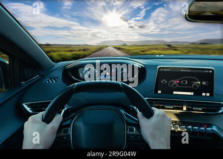 First person view of driving an electric or hybrid car, embracing eco-friendly, sustainable transportation with clean energy and a futuristic automoti Stock Photo