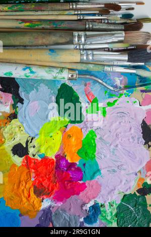 Artist's workshop, background from a palette and brushes for drawing. Stock Photo