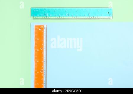 Blue and orange plastic rulers on color background Stock Photo - Alamy