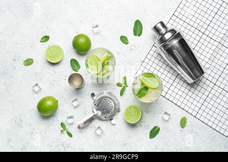 Glasses of tasty mojito and ingredients on light background Stock Photo