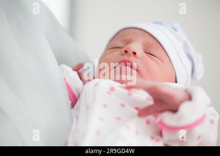 Newborn girl in the hospital on the day of her birth Stock Photo