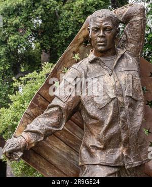 Pasadena, CA, USA - June 8, 2023: Soldier closeup at Enduring Heroes Memorial bronze statue by Christopher Slatoff. Green foliage in back Stock Photo
