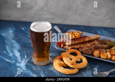 Glass of cold beer and different snacks on table. Oktoberfest celebration Stock Photo