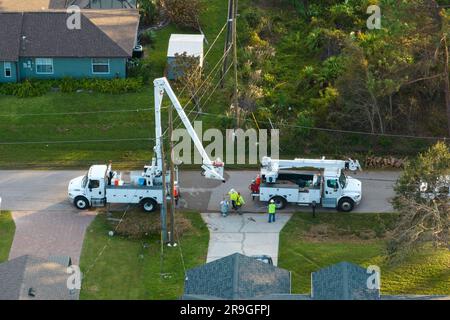 Electrical service company restoring power repairing damaged power lines after hurricane Ian in Florida suburban area Stock Photo