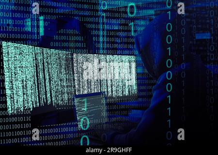 Cyber attack. Hacker working with computers in dark room. Binary code and illustration of lock around him Stock Photo