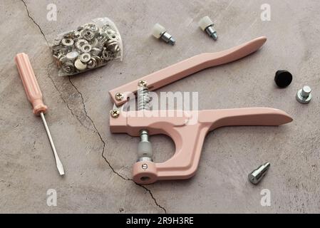 Stud crimper pliers tool set isolated on marble table. Stock Photo