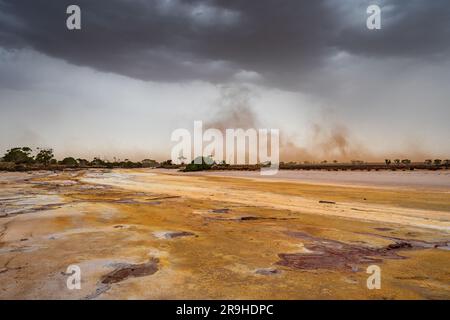 Dust storm under dark clouds over a salt lake at Lake Tyrrell at Sea Lake in Victoria, Australia Stock Photo