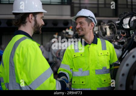 Engineer work at robotic arm factory. Technology and engineering concept. Stock Photo