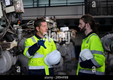 Engineer work at robotic arm factory. Technology and engineering concept. Stock Photo
