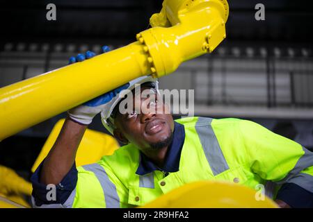 Engineer work at robotic arm factory. Technology and engineering concept. Stock Photo