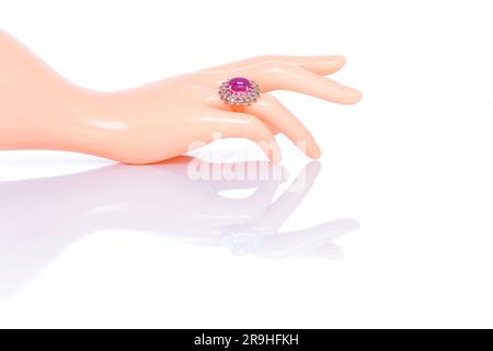 Ruby with pink sapphire and aquamarine jewel or gems ring on plastic mannequin female hand. Collection of natural gemstones accessories. Studio shot Stock Photo