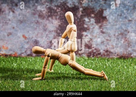Dummy performing push-ups with an instructor. Hard and healthy sport Stock Photo