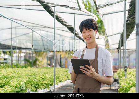 Farmer plantation checking quality by tablet agriculture modern technology Concept. Smart farming, using modern technologies in agriculture Stock Photo