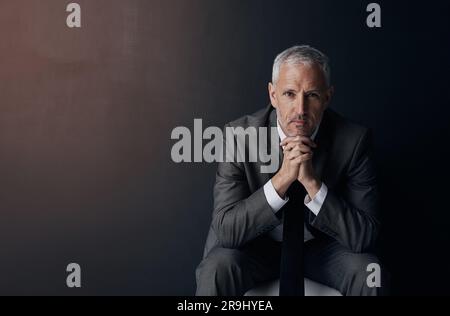 Mockup, chair and portrait of serious businessman, lawyer or attorney with confidence on dark background and studio space. Boss, ceo and professional Stock Photo