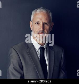 Studio portrait of mature businessman, lawyer or attorney with serious face on dark background. Boss, ceo and professional business owner, senior Stock Photo