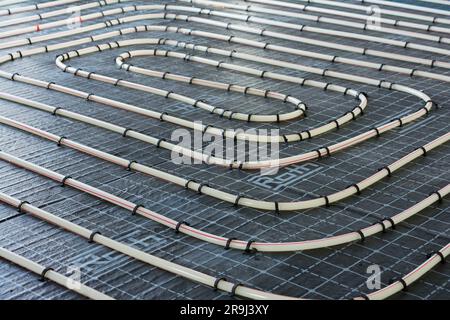 Pipes for underfloor heating in bifilar laying form Stock Photo