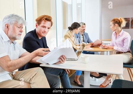 Senior businessman discussing over documents with male colleague Stock Photo